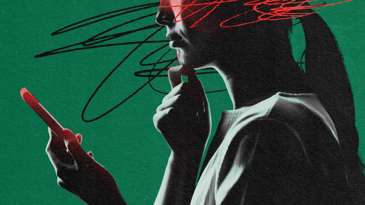 An image of a woman holding a cell phone with potential trigger warnings.