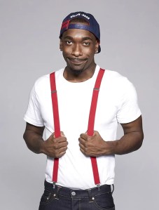 A man wearing suspenders and a hat.