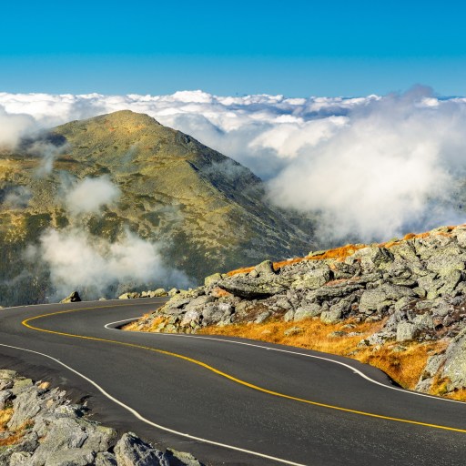 A treacherous winding road on the side of a mountain in the worst weather conditions.