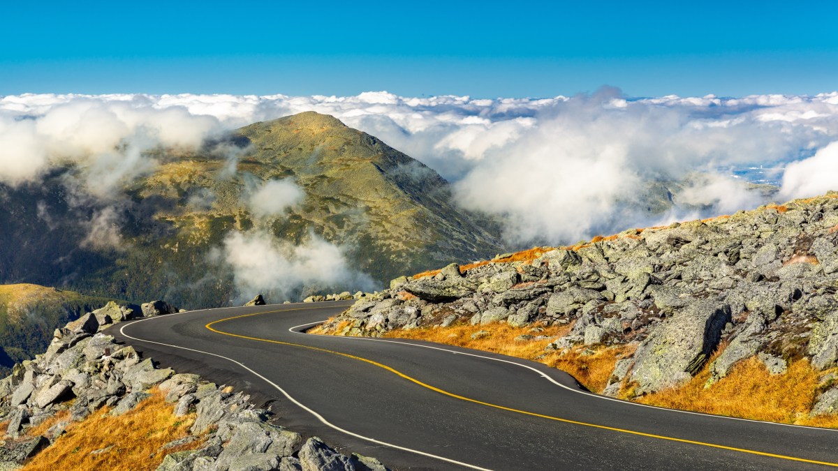 A treacherous winding road on the side of a mountain in the worst weather conditions.
