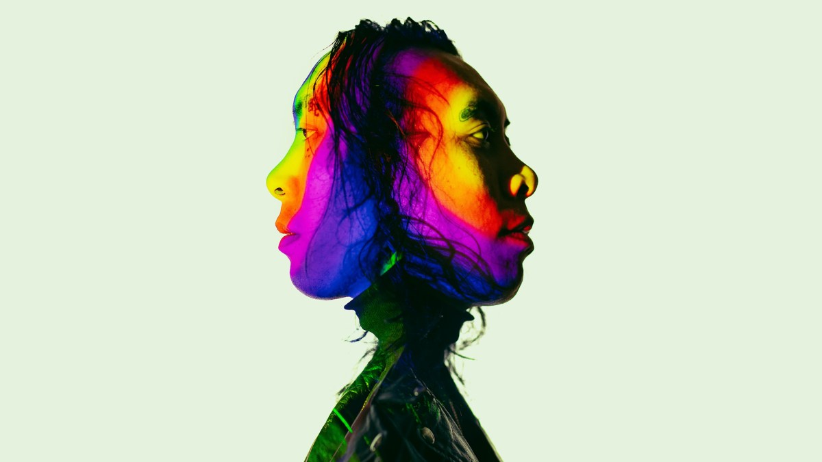 A man's head with a psychedelic rainbow colored face.