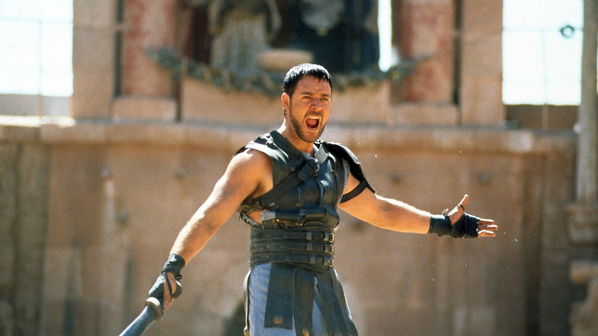 A gladiator brandishing a sword amidst a crowd.