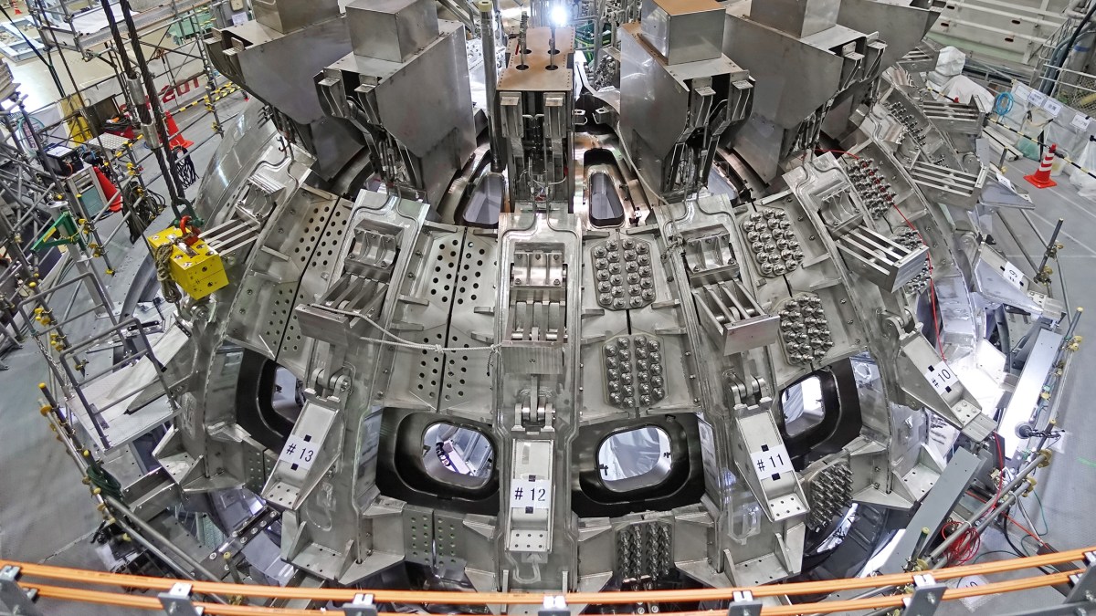 A record-breaking nuclear fusion experiment showcases a large machine in a factory.