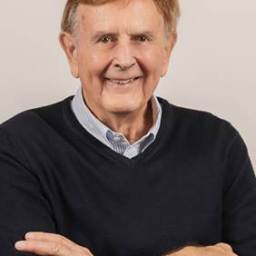 A man in a black sweater with his arms crossed.