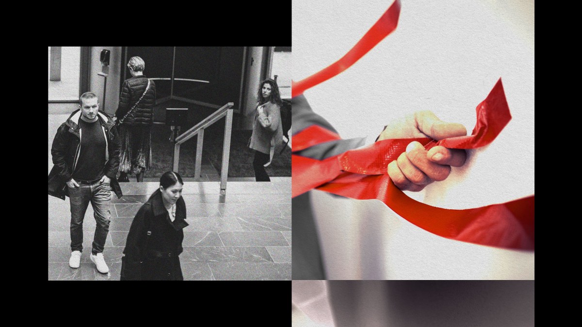 A man is holding a red ribbon, symbolizing the confusion of bureaucracy.