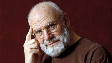 An older man with glasses and a beard posing for a picture.