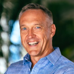 A smiling man in a blue shirt.