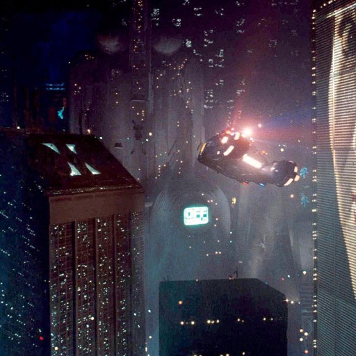 An image of a pop-culture city with a woman in the sky, representing future visions.