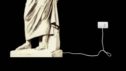 A marble statue with feet and draped clothing stands next to a wall outlet, connected by a white power cord against a black background.