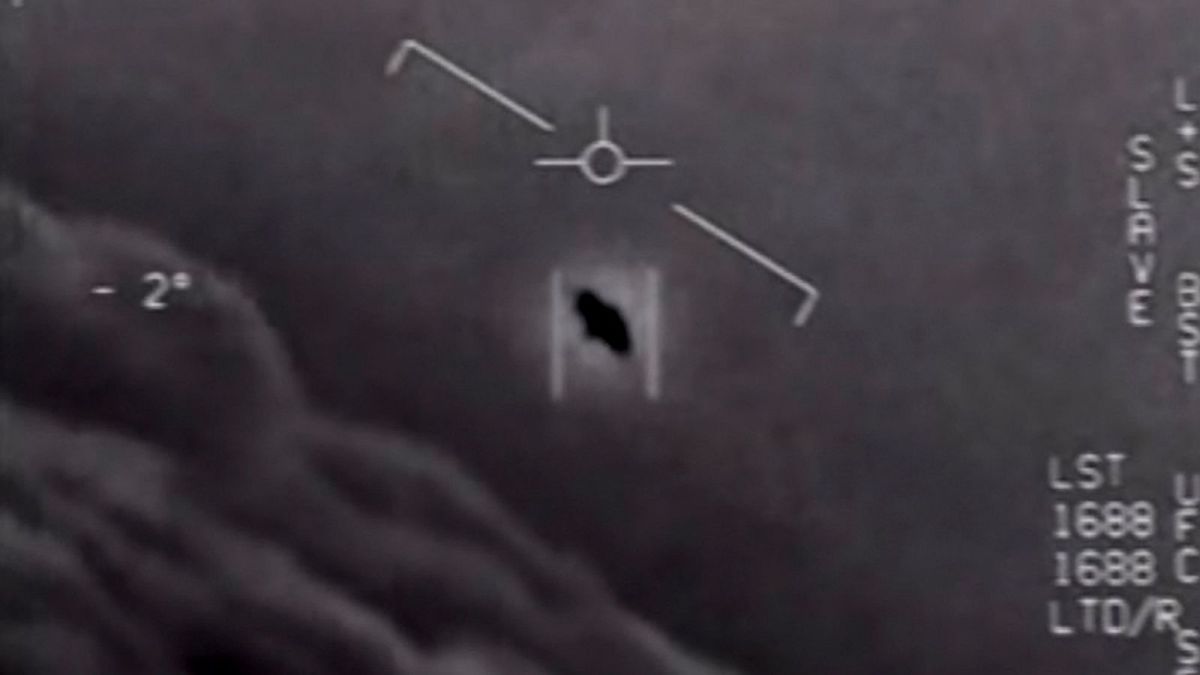 Grayscale image showing a flying object captured on radar screen with various data markings.