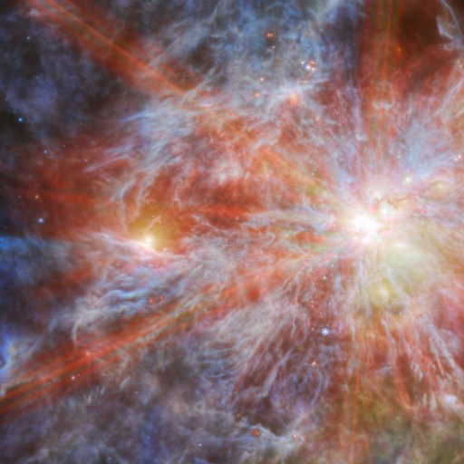 A colorful cosmic scene features a bright super star cluster with glowing stars surrounded by swirling red, orange, blue, and gray nebulous clouds.