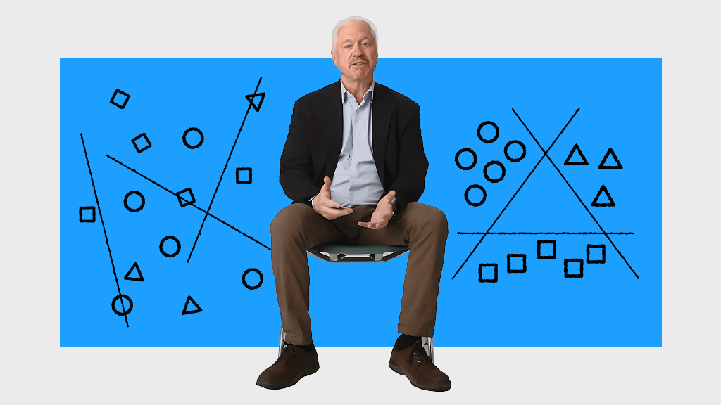 A person sits on a stool against a blue background with black and white geometric diagrams, including lines, circles, squares, and triangles.