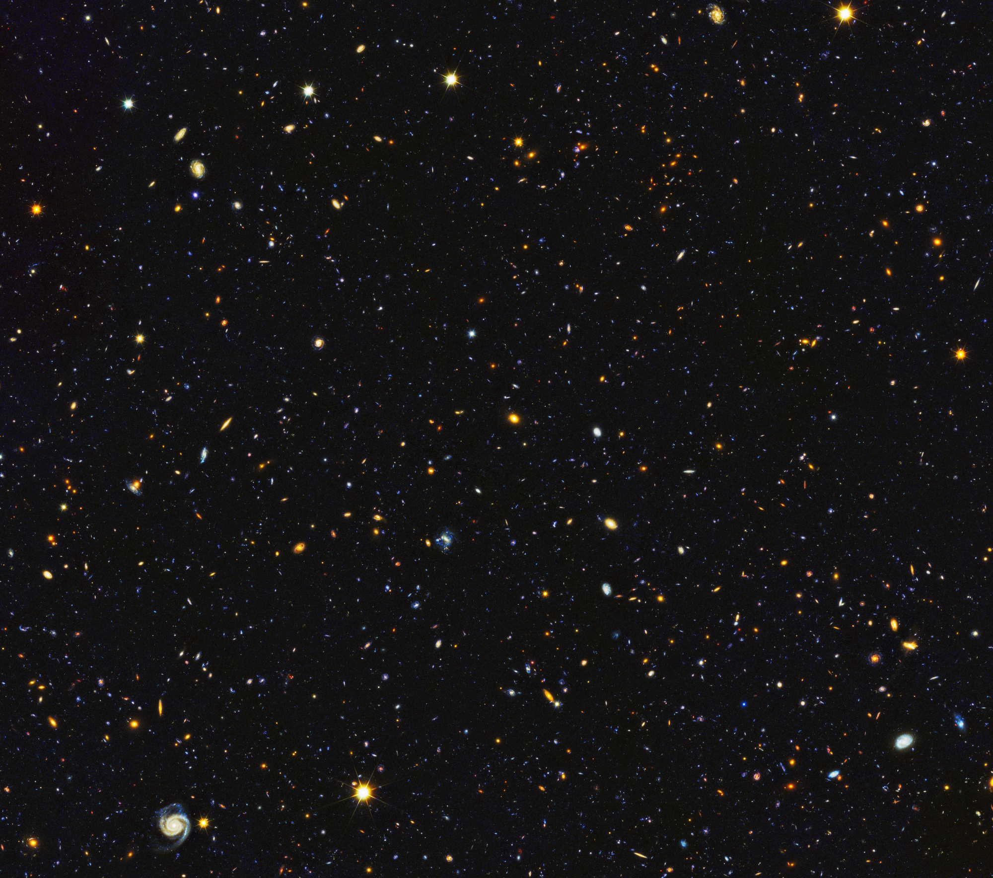 A vast view of numerous galaxies and stars scattered across a dark background in deep space, brighter than astronomers ever imagined.