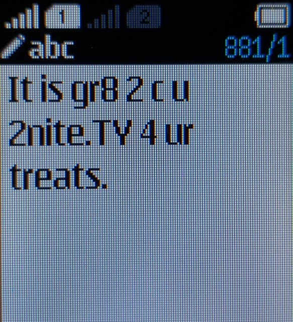 Close-up of a phone screen showing a text saying: "It is gr8 2 c u 2nite. TY 4 ur treats.