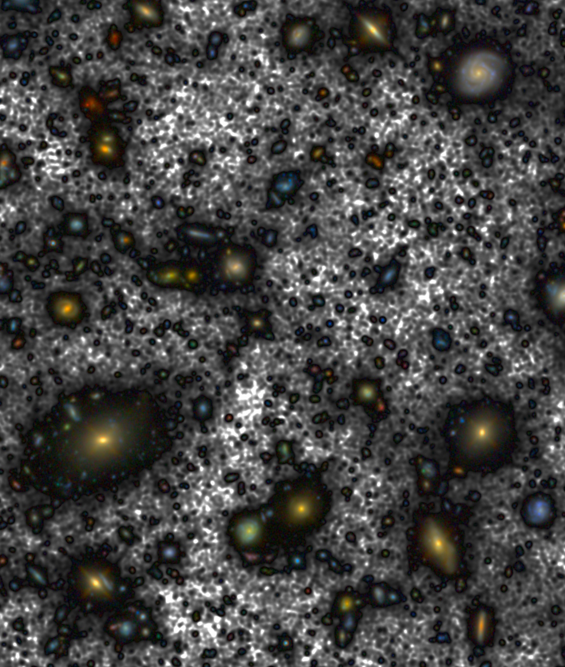 Image of numerous distant galaxies captured by a telescope, with a mix of vibrant colors and faint details against a dark background. This celestial view is brighter than astronomers imagined, revealing cosmic structures and star formations in exquisite detail.