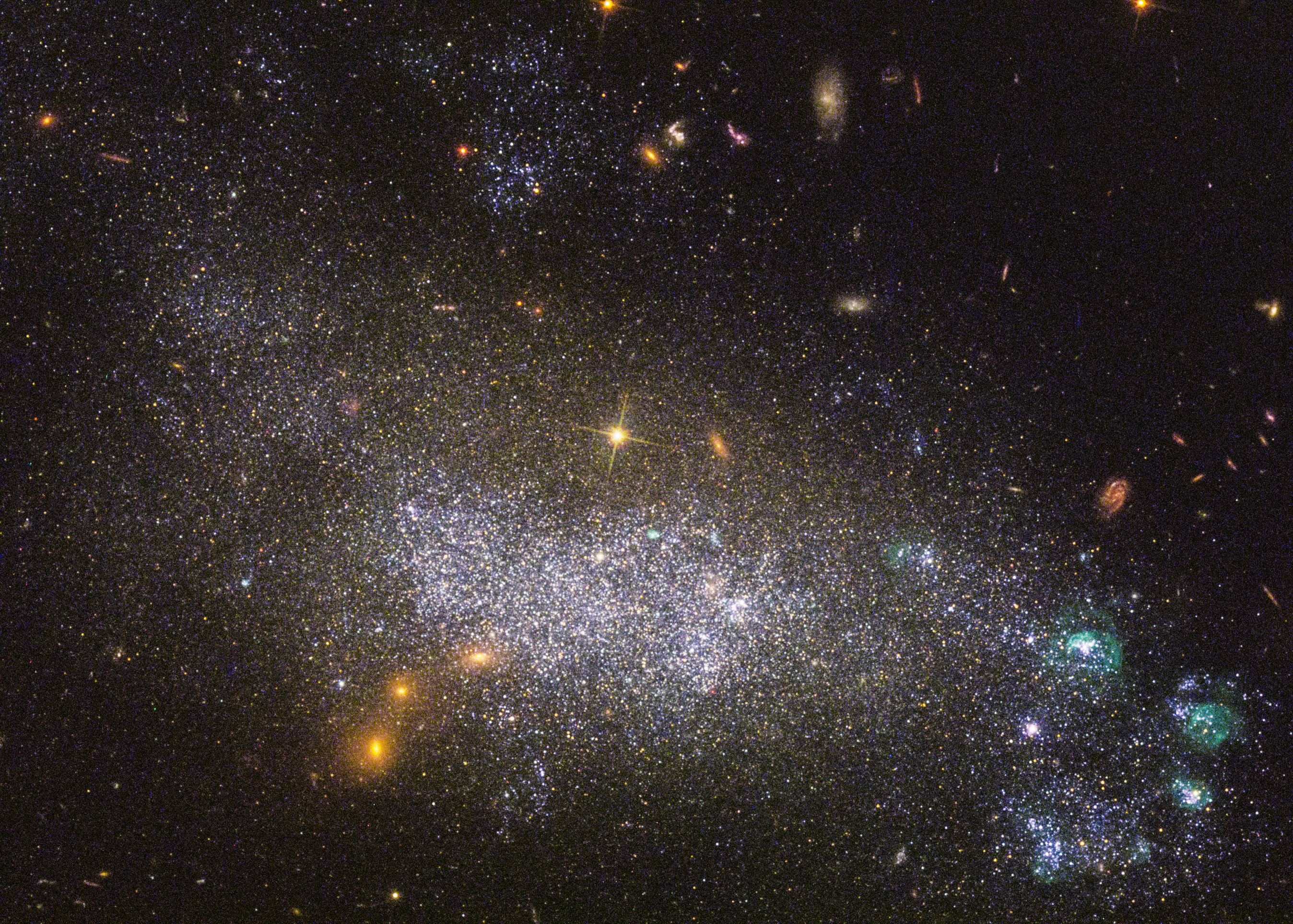 A dense star field in deep space features countless bright stars, glowing clusters, and distant galaxies set against a black background—reminding us how vast space can sometimes deceive the eye with its mysterious appearance.