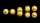 A sequence of six yellow-gold spheres illustrates stages of cell division against a black background.