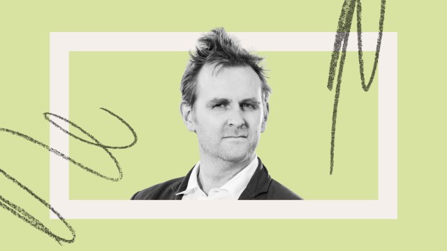 A man in a suit looks at the camera with a neutral expression, set against a light green background with abstract black scribble accents.