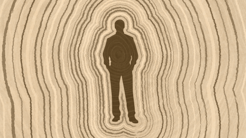 Silhouette of a person standing with hands in pockets, surrounded by concentric oval lines resembling tree rings that symbolize lifespan, in various shades of brown.
