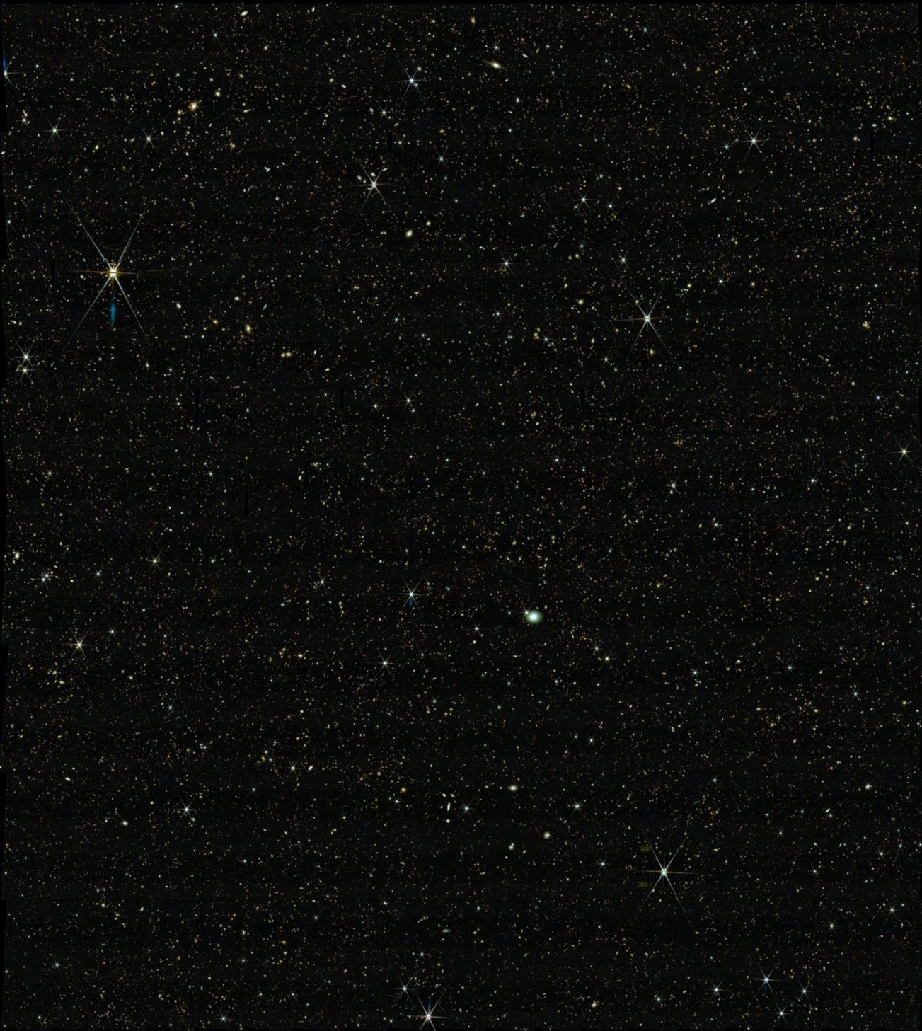 A dense field of stars scattered across a dark night sky, with some stars—and distant galaxies—appearing brighter and larger than others, as revealed by JWST science.