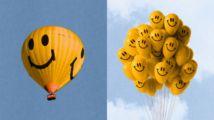 A large yellow hot air balloon with a smiley face is shown on the left; on the right, a bunch of parfit smiley face balloons float against a cloudy sky.