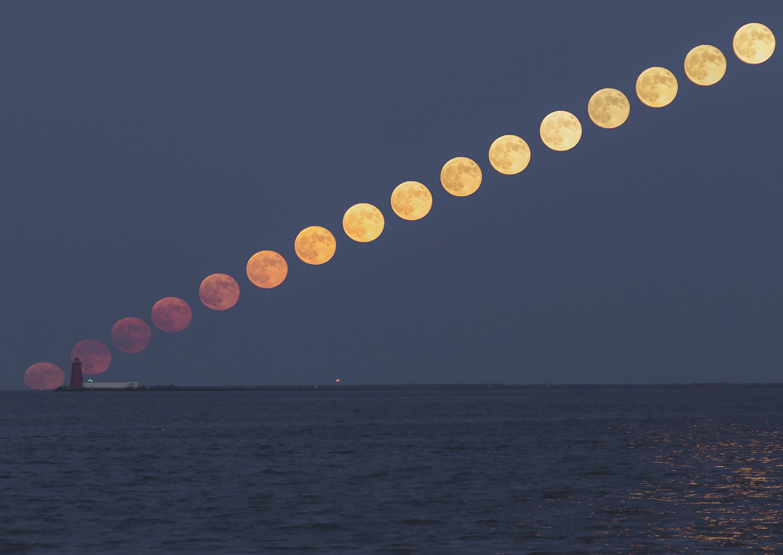 A composite image showing the sequence of a full moon rising diagonally over a lighthouse by the water at dusk, perfect for illustrating 5 science lessons about the moon’s phases and movement.