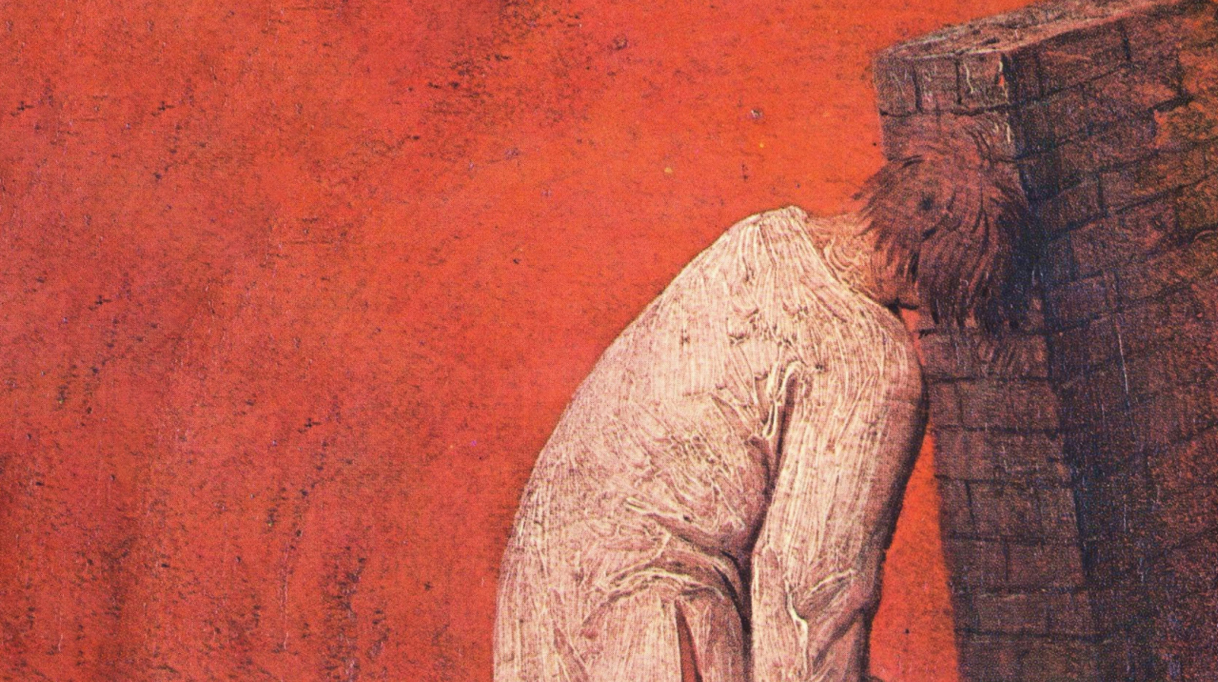 A person in a long, light-colored garment leans forward with their head pressed against a brick wall against a red background.