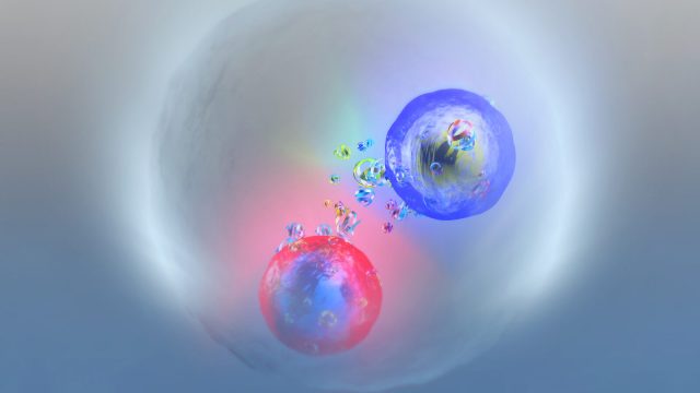 Two colorful, semi-transparent spheres, one blue and one red, represent a possible top quark bound state, toponium, surrounded by small particles inside a cloudy, circular enclosure.