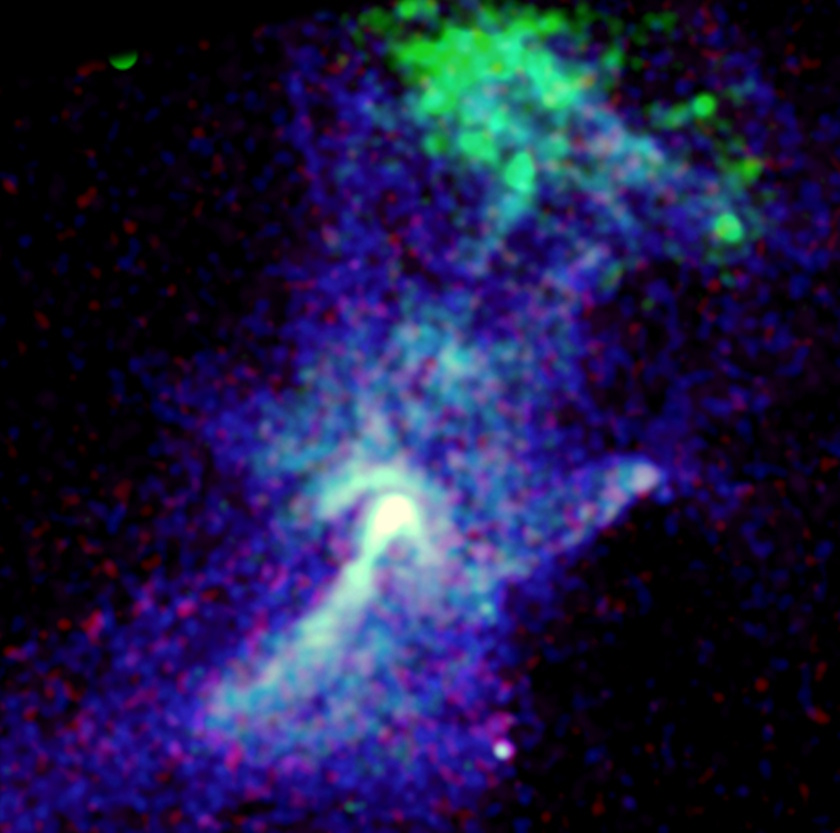 False-color astronomical image showing a cloud-like structure carved by a dead star, with bright blue and green regions, set against a dark background with scattered red and blue specks—evoking the famed "Hand of God" effect.