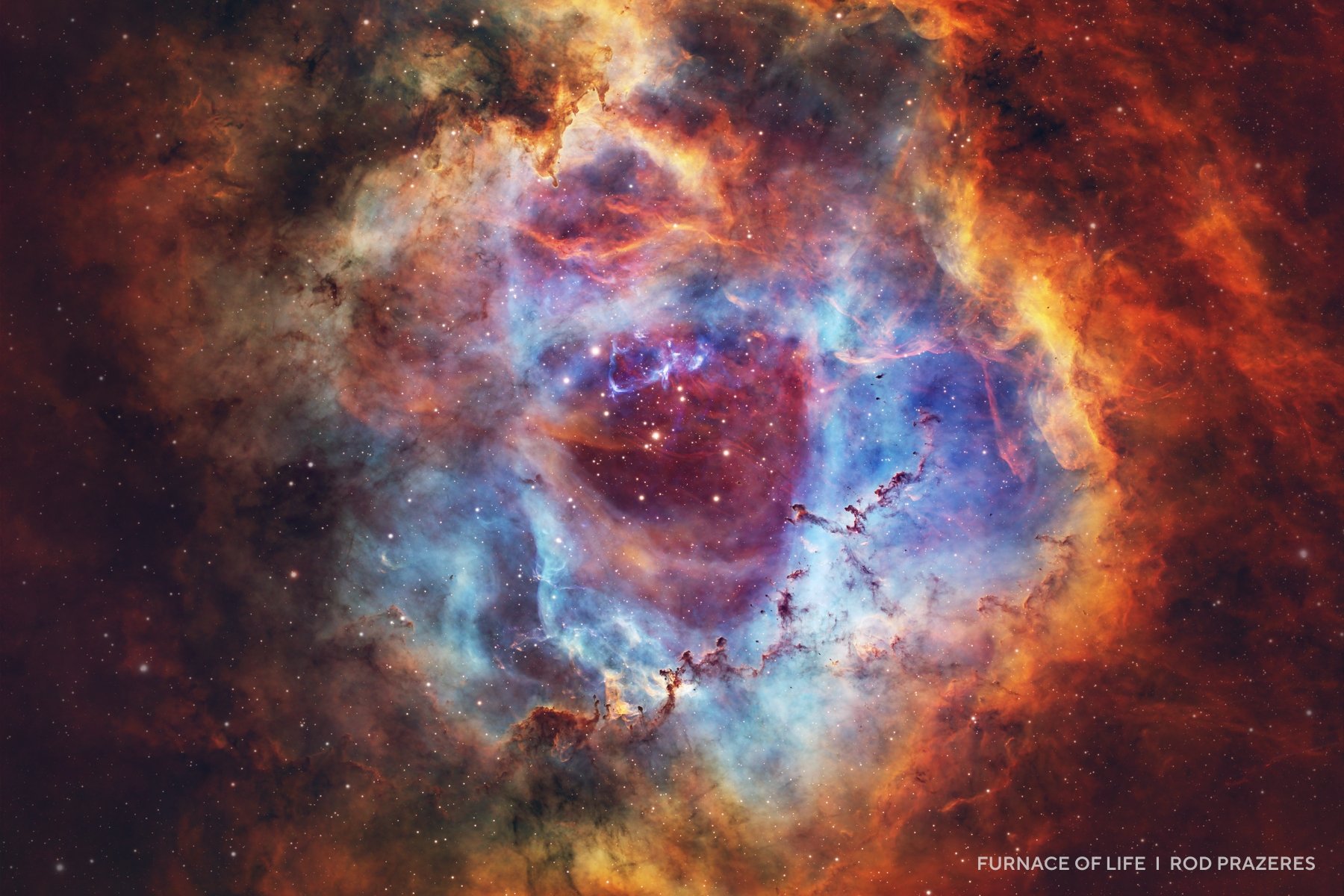 Colorful nebula with blue, orange, and red clouds of gas and dust, featuring bright stars scattered throughout the center—a stunning example of cosmic beauty captured in 2025 night sky images.