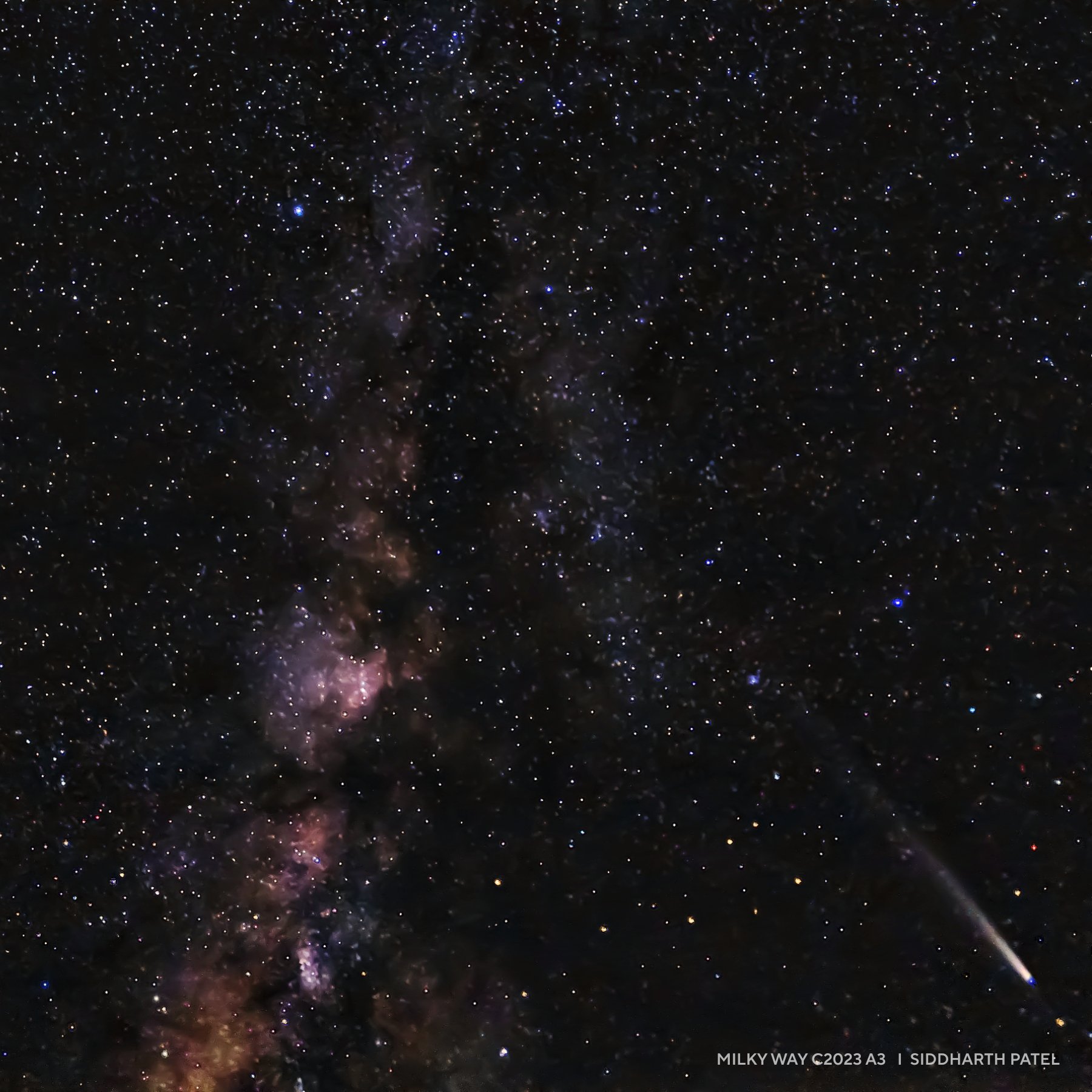 A night sky featuring the Milky Way galaxy, dense clusters of stars, and a bright meteor streaking across the lower right corner—perfect for those seeking inspiring 2025 night sky images.