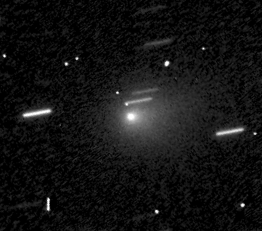 A grainy black and white image shows SPHEREx comet 3I/ATLAS gleaming at the center, surrounded by stars appearing as streaks due to long exposure.
