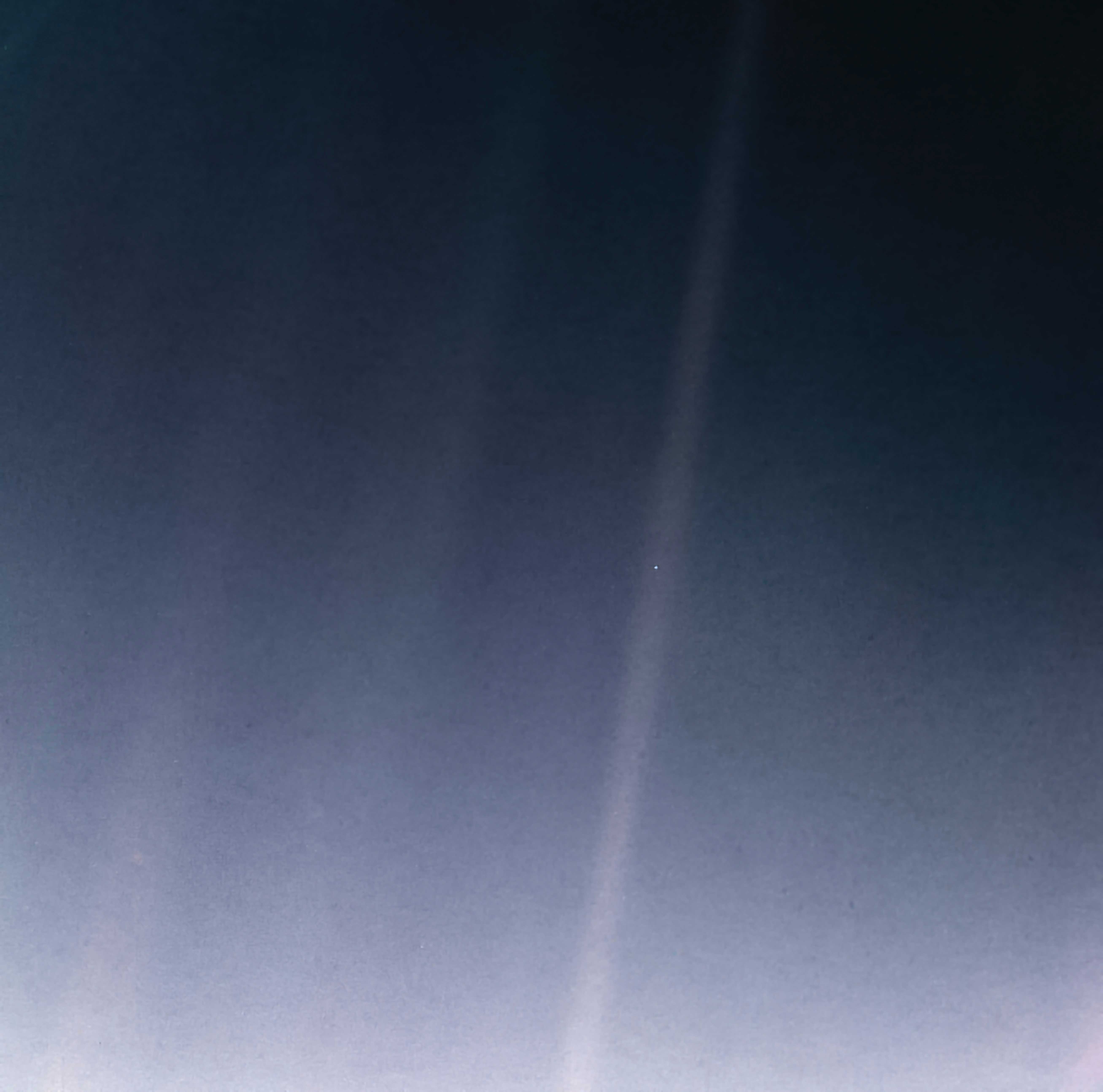 A faint, pale blue dot appears near the center of a dark, gradient sky with vertical light streaks crossing the image.