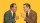 Two men in suits face each other against a yellow background, one yelling with a clenched fist, the other pointing and appearing angry.