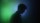Silhouette of a person in profile against a gradient background of green and blue light.