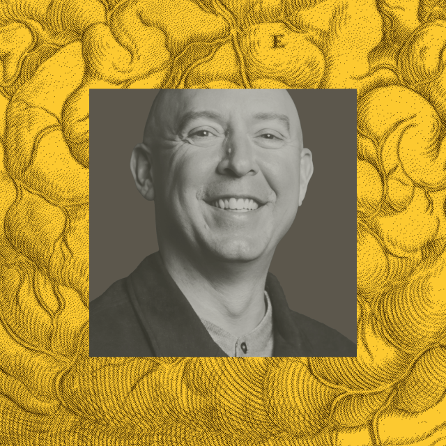 Smiling bald man in a collared shirt, centered in a grayscale photo against a yellow background with abstract swirling patterns.