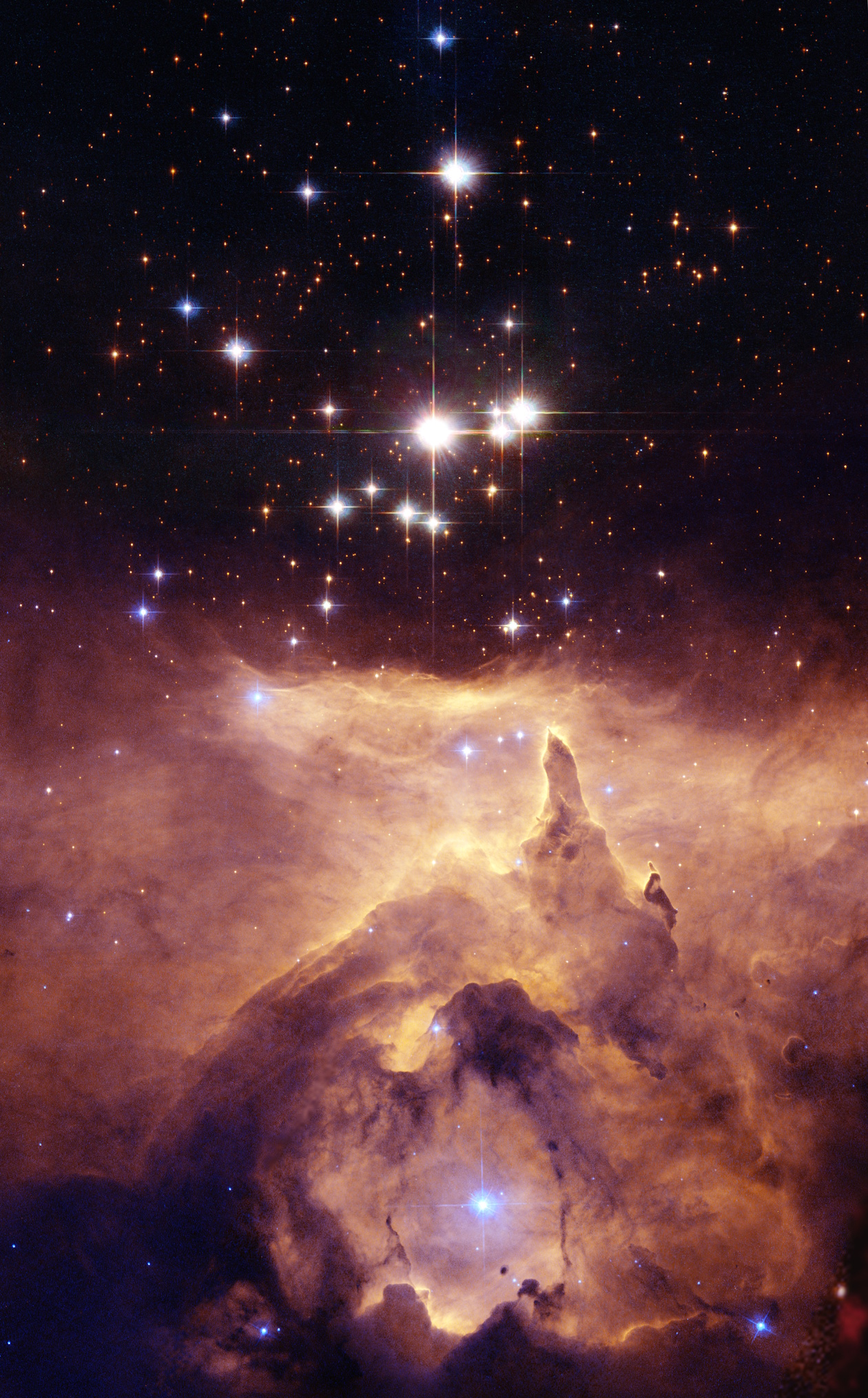 A bright star cluster, Pismis 24, shines above an orange and purple cloud of interstellar gas and dust in a region of space captured by JWST and Hubble.