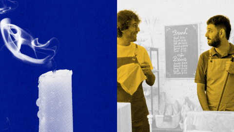 A white candle with smoke rising from its wick is shown on the left; on the right, two men wearing aprons stand talking in front of a café menu.