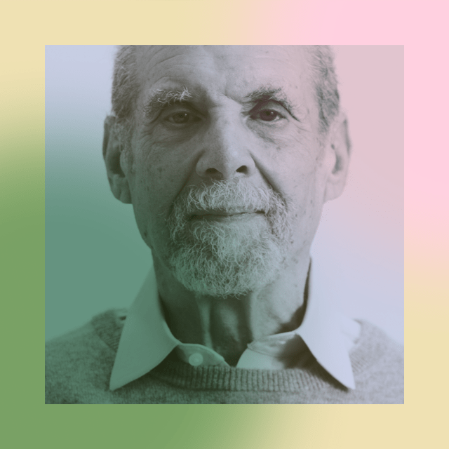 Elderly man with a beard and mustache wearing a collared shirt and sweater, shown in a portrait with a pastel gradient overlay.