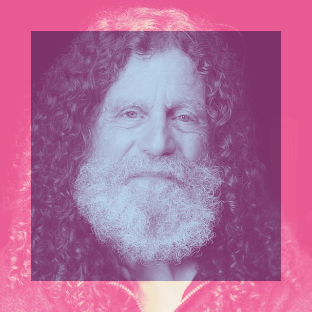 Elderly man with long curly hair and a full white beard, centered in a pink-tinted square frame with a pink background.