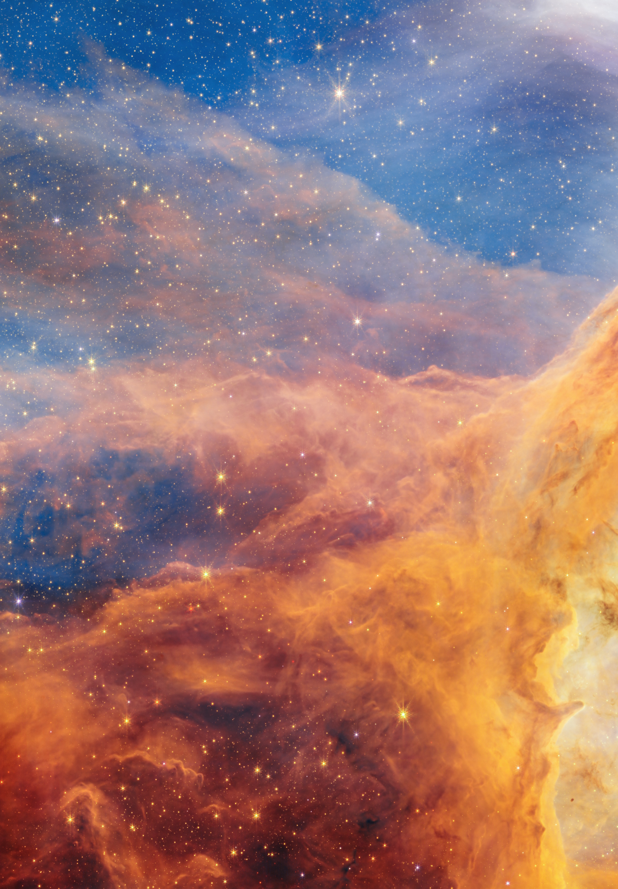 Colorful nebula in space with clouds of orange, yellow, and blue gas, bright stars scattered throughout, and a dark sky background as captured by JWST and Hubble near the Pismis 24 star cluster.