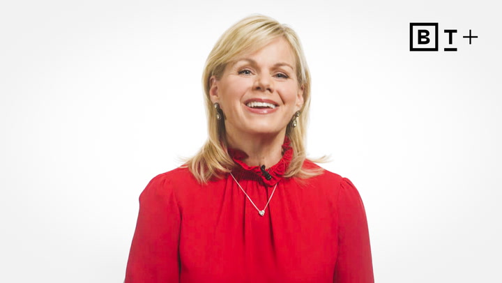Woman with blonde hair wearing a red blouse and silver necklace smiles in front of a plain white background with a "B T +" logo in the top right corner.