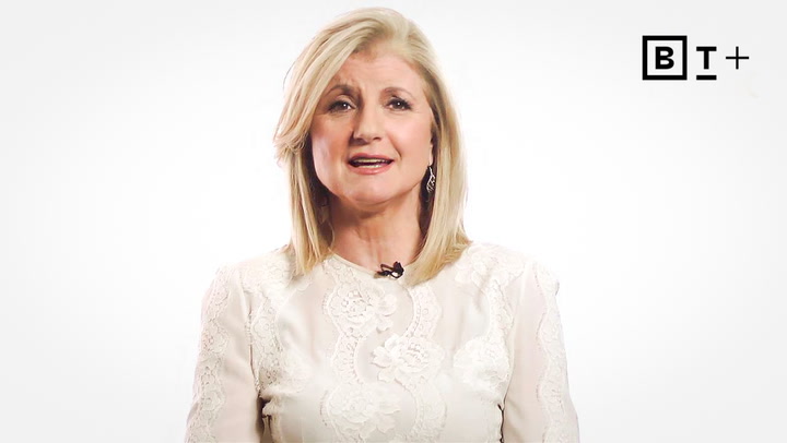 A woman with blonde hair wearing a white lace top speaks in front of a plain white background with a "BT+" logo in the top right corner.