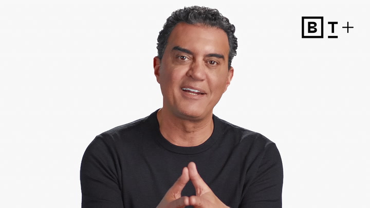 A man with short curly hair wearing a black shirt sits against a white background with a "BT+" logo in the top right corner.