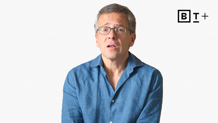 A middle-aged man in glasses and a blue button-up shirt sits against a plain white background with a "BT+" logo in the top right corner.