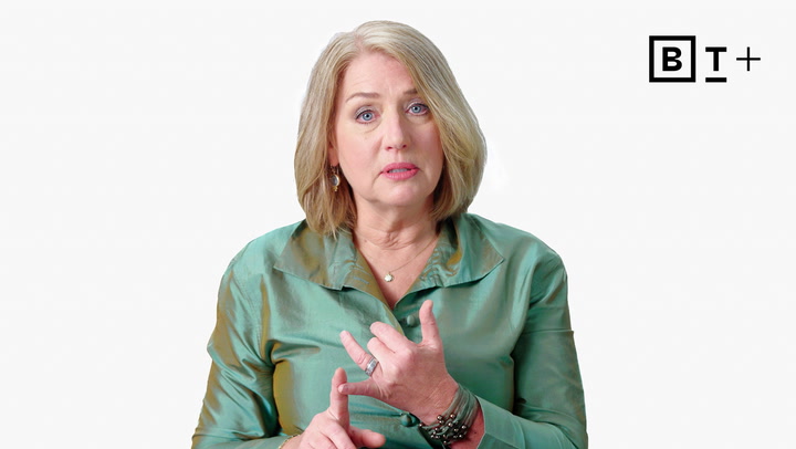A woman with blonde hair in a green blouse gestures with her hands while speaking, with a "BT+" logo in the top right corner against a plain white background.
