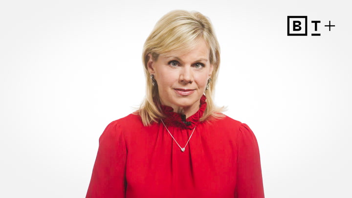 A woman with blonde hair wearing a red blouse and a necklace stands against a white background with the B T Plus logo in the top right corner.