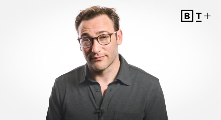 A person with short brown hair and glasses wearing a dark collared shirt stands against a plain white background with a "B T+" logo in the top right corner.