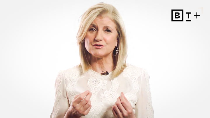 A woman with blonde hair wearing a white lace top speaks, gesturing with her hands. A logo with the letters "BT+" is in the top right corner on a plain white background.