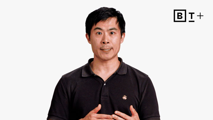 A man in a black polo shirt stands against a plain white background with a B T+ logo in the top right corner.
